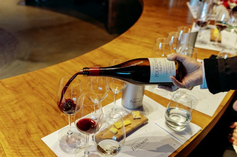 Red wine being poured into a glass during a tasting at Zuccardi winery in Mendoza.